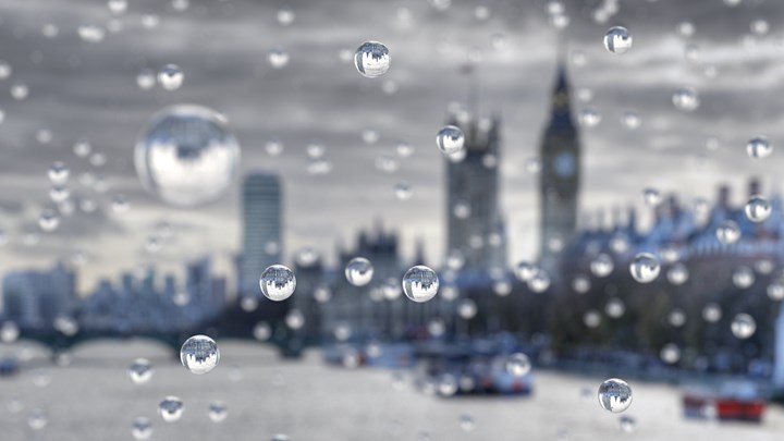 Raindrops on a windowpane looking out across the London cityscape